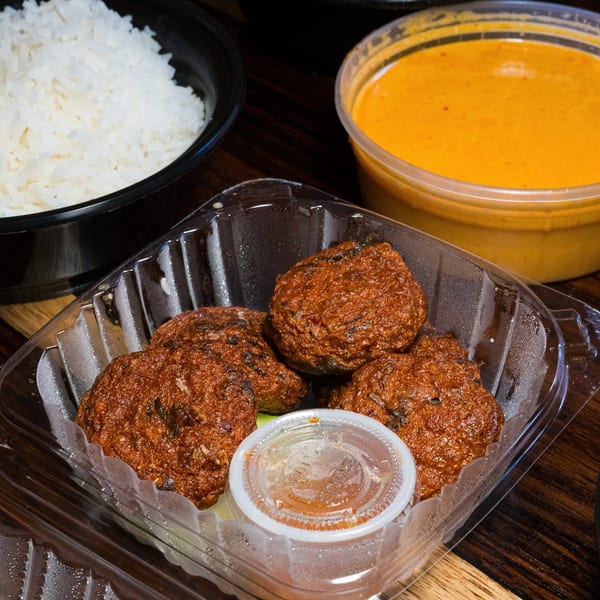 Gai Kitchen's Thai fish cakes with sauce, rice, and curry in takeout containers.